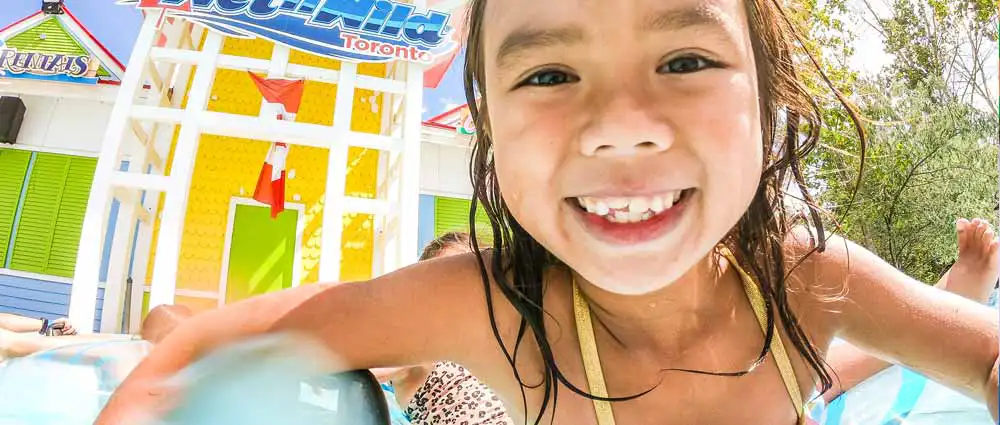 little-girl-lazy-river-smile Little girl floating in a tube on the lazy river