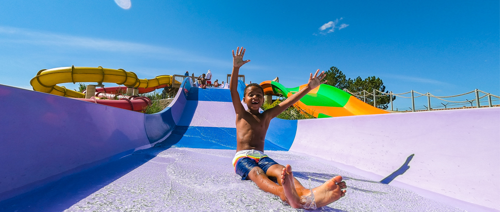 boy-on-slide-with-hands-up Boy on water slide with his hands in the air